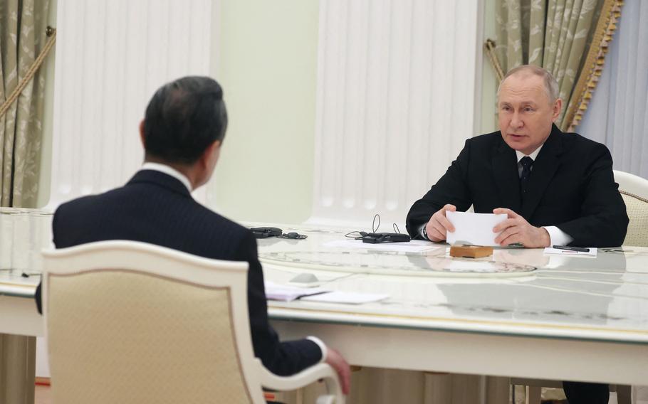 Russian President Vladimir Putin meets with China’s Director of the Office of the Central Foreign Affairs Commission Wang Yi at the Kremlin in Moscow on Feb. 22, 2023.