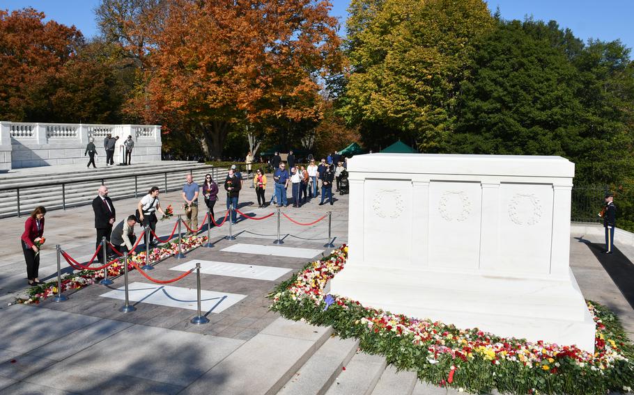 A line of people wait to place flowers at the base of the Tomb of the Unknown Soldier on Wednesday, Nov. 10, 2021. For the first time in recent history, Arlington National Cemetery allowed members of the public to approach the tomb. The event was held to commemorate the 100th anniversary of the site. 