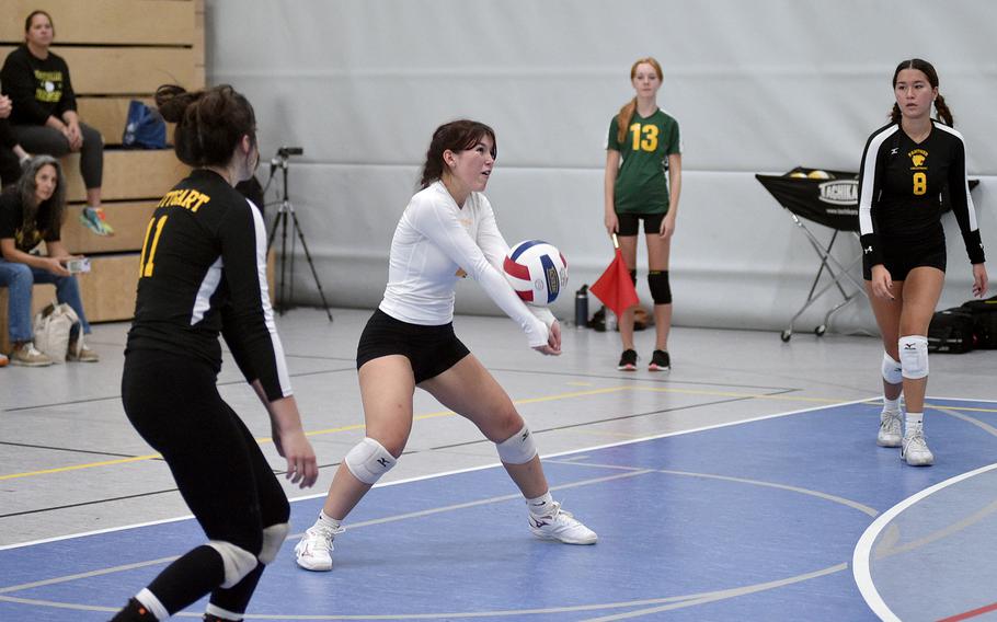 Stuttgart libero Bella Whaley bumps the ball during a scrimmage on Sept. 1, 2023, at Ramstein High School on Ramstein Air Base, Germany. Following are Panthers Mia Snyder, left, and Charity Clements, right.