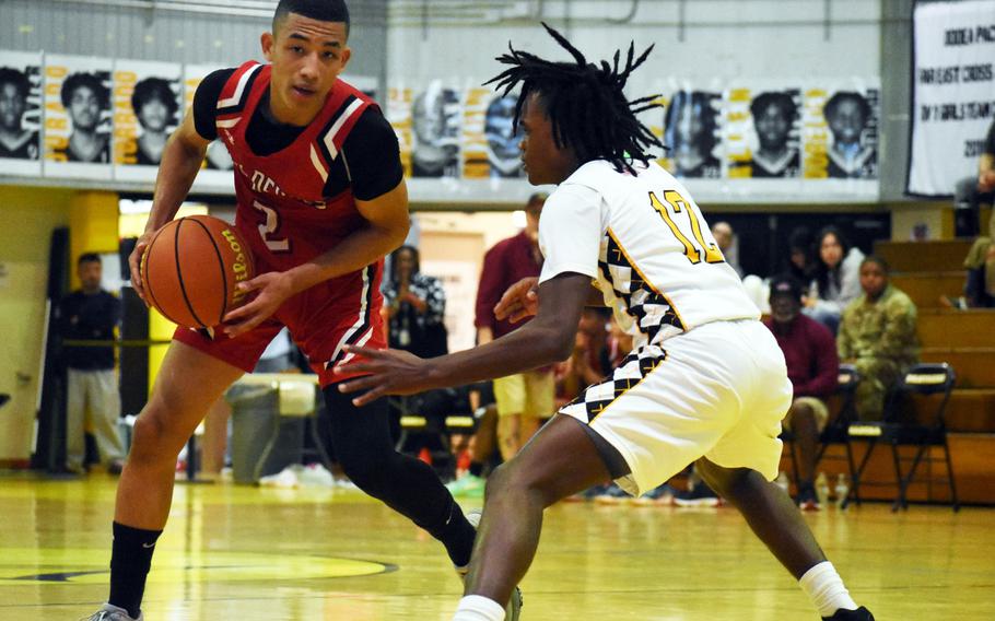 Kinnick's Vance Lewis looks for room against Kadena's DeShaun Nixon.