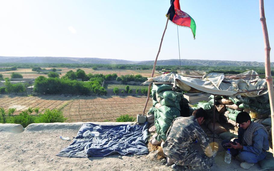 Afghan National Security Forces fighters stake out a roof overlooking Sangin District's "green zone." The green zone is where fighting for Sangin was most intense last week, since the vegetation offered insurgents cover and made it easy for them to hide IEDs.