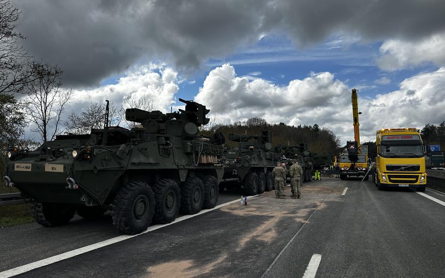 Service members wait while a Mine Resistant Ambush Protected vehicle is recovered after a crash April 17, 2023, on highway A6 near Amberg, Germany. Seven military vehicles were traveling between Sulzbach-Rosenberg and Amberg-West when the collision occurred.