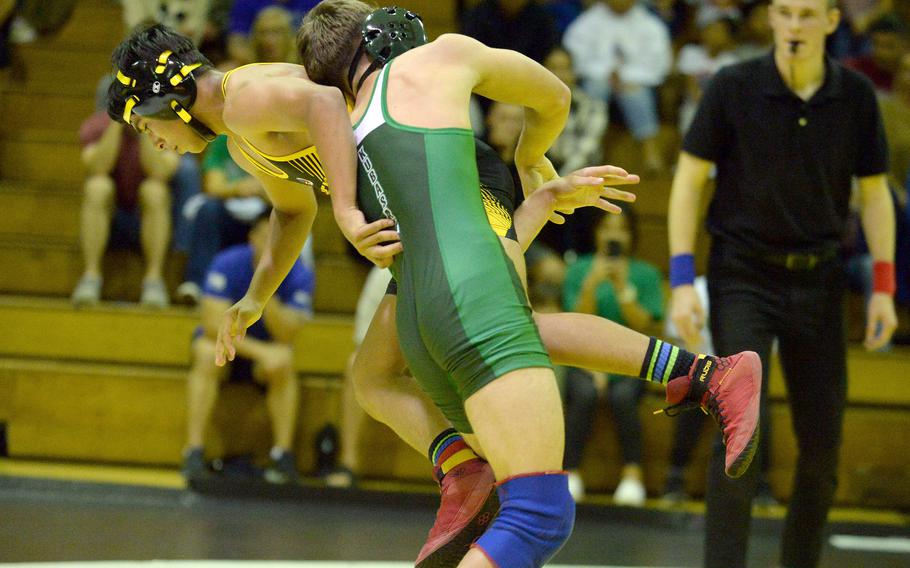 Kubasaki's Timothy Cope lifts Kadena's Ryan Luckey during Wednesday's Okinawa wrestling dual meet. Cope won by technical fall 13-2 in 2 minutes, 36 seconds, but the Panthers won the meet 42-15.