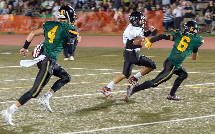 Zama's Roman Romero tries to cut around left end while Robert D. Edgren defenders Parker Kuns and P.J. Lorenzo pursue.