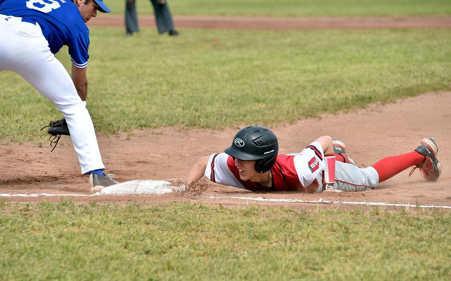Kaiserslautern junior Trygg Bredlow dives back to first base during a pick-off attempt at a Division I DODEA European basesball semifinal against Ramstein on May 19, 2023, at Soutside Fitness Center on Ramstein Air Base, Germany.