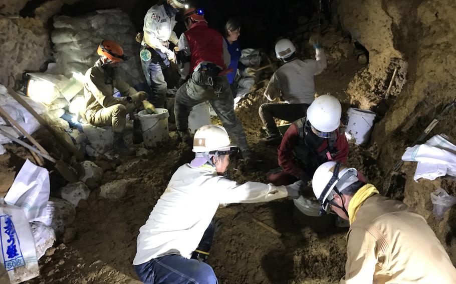 Members of Kuentai-USA and volunteers excavate a cave in Itoman, Okinawa, July 11, 2022, as they look for the remains of Marines lost during World War II.