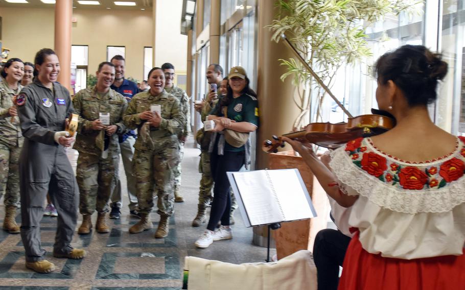 Rina Cameron plays violin alongside other musicians during a Hispanic Heritage Month celebration at Yokota Air Base, Japan, Sept. 15, 2023.