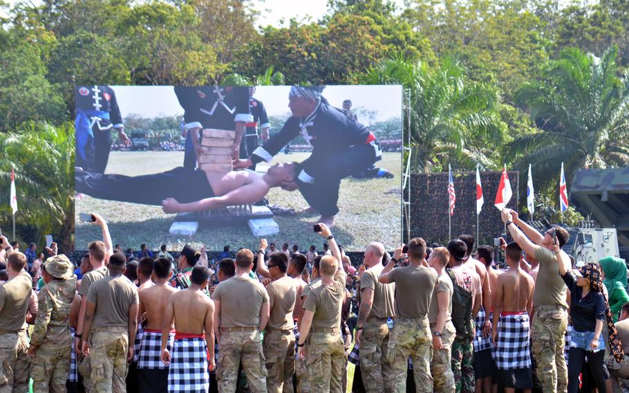 Hundreds of soldiers watch Indonesian troops display their martial arts skills at Baturaja Training Area, Indonesia, Saturday, Aug. 13, 2022. 