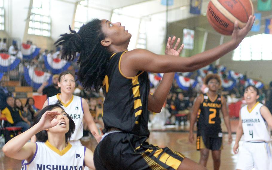 Kadena's NyKale Penn goes up for a reverse layup against Nishihara A during Saturday's pool-play game in the 16th Okinawa-American Friendship Basketball Tournament at the Camp Foster Field House. The Owls routed the Panthers 109-24.