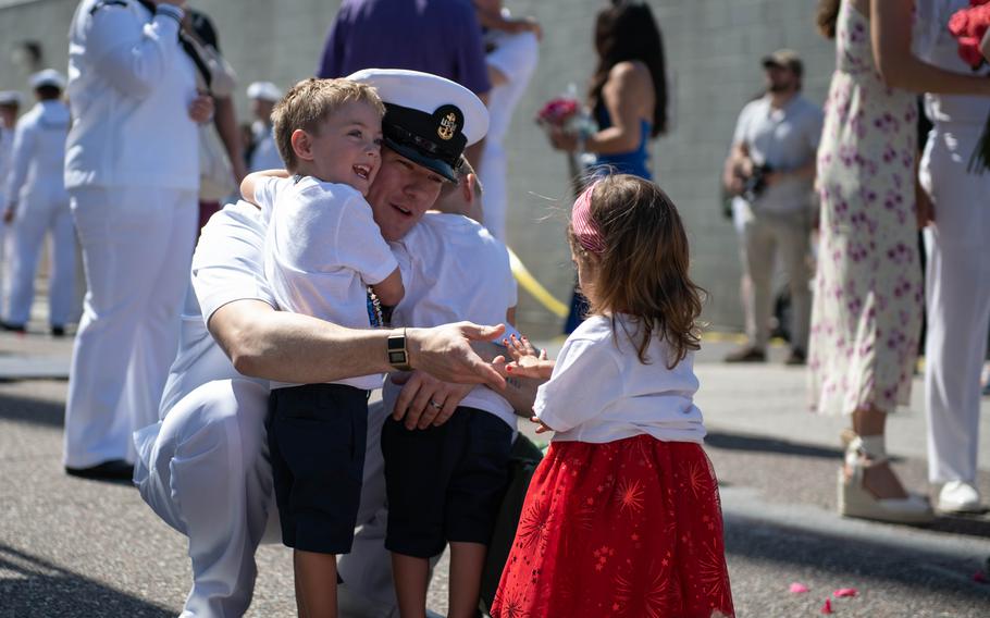 Chief Operations Specialist Noah Wicks of McAlisterville, Pa., greets his children after returning home from deployment aboard the USS Carney on Sunday, May 19, 2024, at Naval Station Mayport, Fla. 