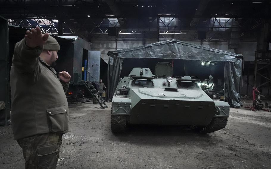 Ukrainian National Guard soldiers repair captured Russian armoured personnel carrier (APC) outskirts Kharkiv, Ukraine, Thursday, Nov. 3, 2022. 