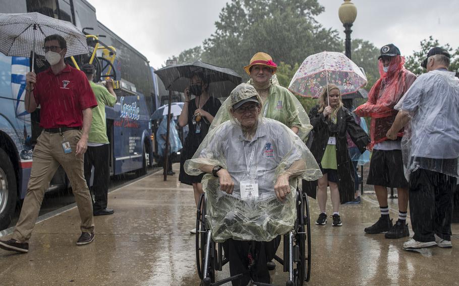 Marine Corps veteran Gene Meske arrives at the World War II Memorial in Washington, D.C., on Wednesday, Aug. 18, 2021, as the rain pours down prior to an Honor Flight ceremony that paid tribute to veterans from World War II, the Korean War and the Vietnam War.