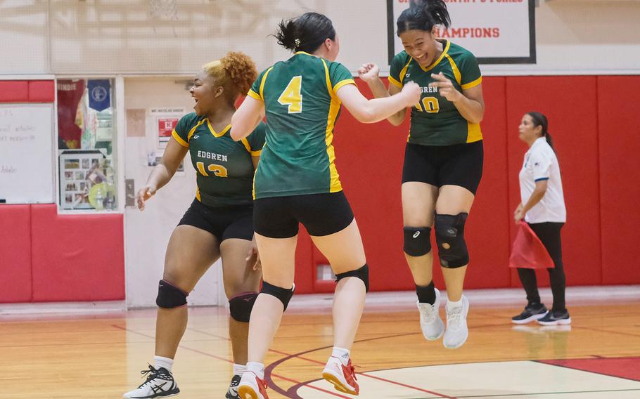 Robert D. Edgren's Genesis Miller, Milan Bean and Katerina Sili celebrate their four-set victory Saturday over Nile C. Kinnick in a DODEA-Japan girls volleyball match. The Eagles and Red Devils split their two weekend matches.