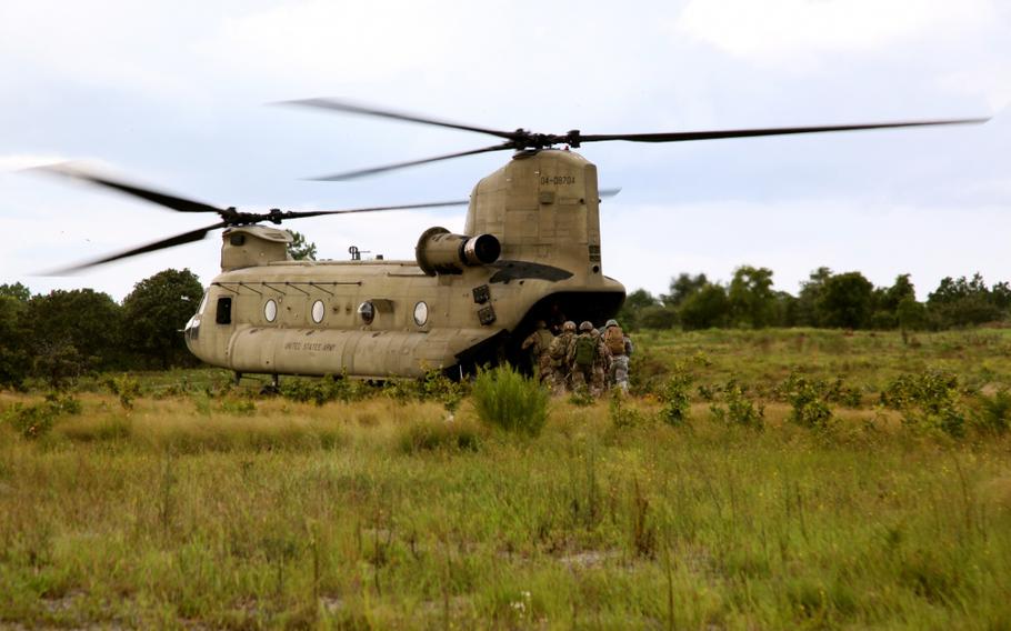 Soldiers load a CH-47 Chinook following training at Fort Bragg, N.C., on Sept. 8, 2015. Helicopter training for 100 Fort Bragg-based special operations soldiers upset some Bloomington, Indiana, residents unaware of U.S. Army plans for training in town.