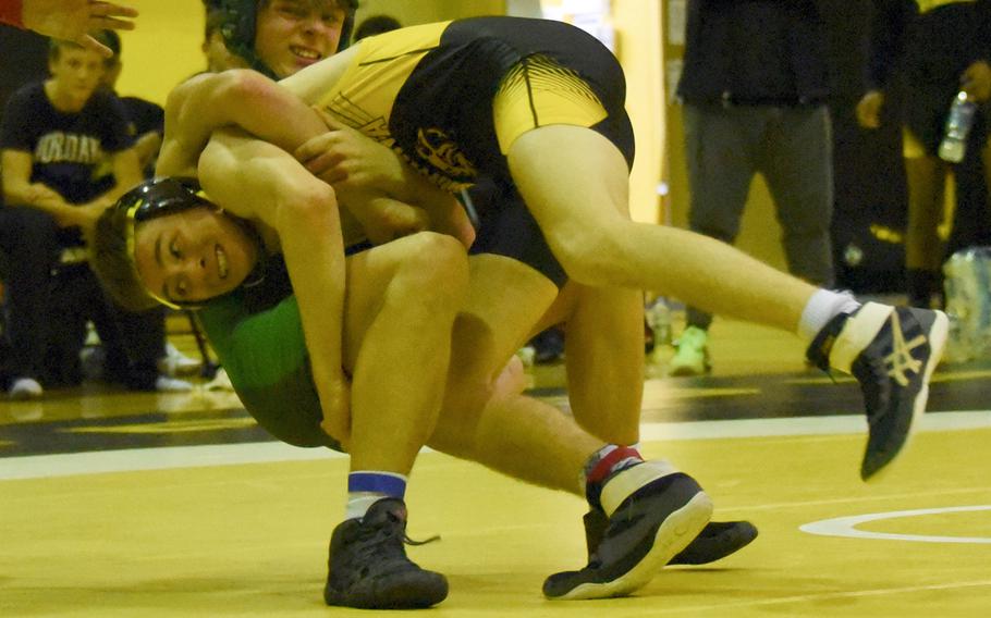 Kadena's Bruce Young sends Kubasaki's Nathan Voelkel to the mat at 135 pounds during Wednesday's Okinawa wrestling dual meet. Young won by technical fall 13-2, but the Dragons won the meet 39-26.