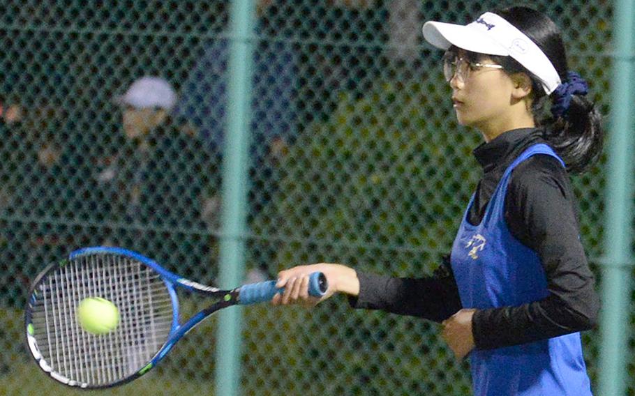 Yokota's Taylor Zhang slaps a forehand against Christian Academy Japan's Soomin Cho during Wednesday's Kanto Plain tennis matches. Cho won 8-5.