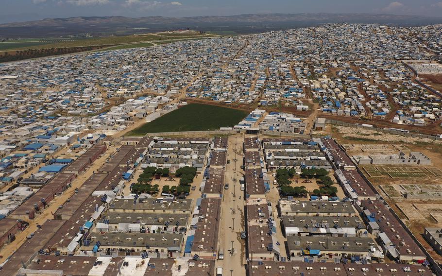 In this April 19, 2020, file photo, shows a large refugee camp on the Syrian side of the border with Turkey, near the town of Atma, in Idlib province, Syria.