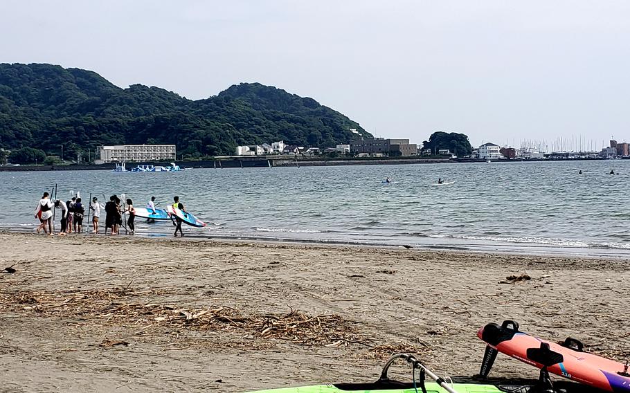 Beachgoers enjoy the water and sand in Zushi, Japan, June 26, 2023.