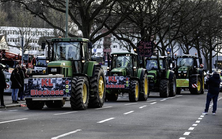 A convoy of tractors lines up in Kaiserslautern, Germany, Jan. 8, 2024, as farmers launch a week of protests against agricultural subsidy cuts, which they say are threatening the future of farming in Germany.