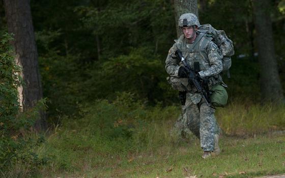 Spc. Ryan Montgomery, an infantryman with the Arkansas National Guard’s Company D, 2nd Battalion, 153rd Infantry Regiment, emerges from the tree line toward a warrior task and battle skill lane at the 2014 Department of the Army Best Warrior Competition at Fort Lee, Va., Oct. 7, 2014. Montgomery represented the Army National Guard as its top enlisted Soldier of the year. (Army National Guard photo by Staff Sgt. Darron Salzer, National Guard Bureau/Released)