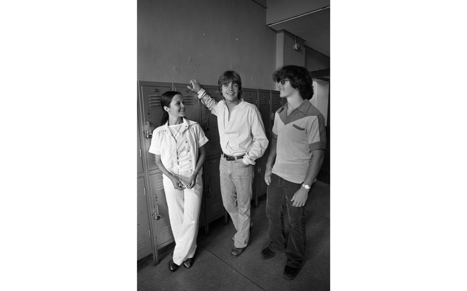 Mark Hamill, better known to many as young Jedi Luke Skywalker of Star Wars fame, chats with Melanie Shriver (18) and an unidentified student in the hallways of Nile C. Kinnick High School, the Jedi’s own alma mater.