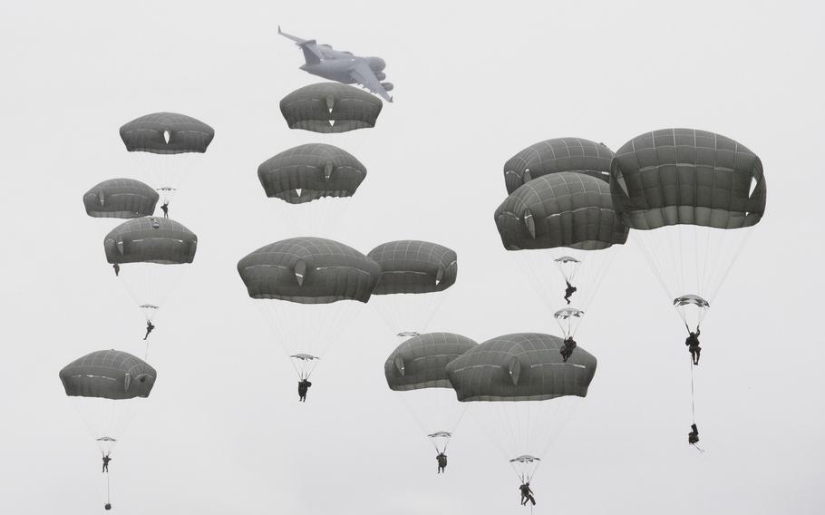 Army paratroopers with the 11th Airborne Division descend over Malemute Drop Zone, Joint Base Elmendorf-Richardson, Alaska, Oct. 20, 2022.