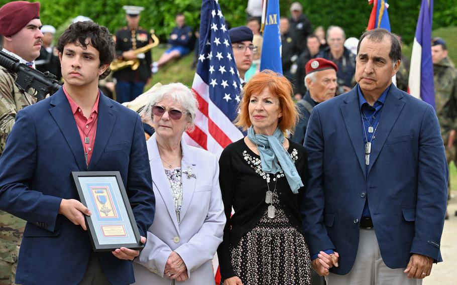Relatives observe a ceremony posthumously honoring a loved one.