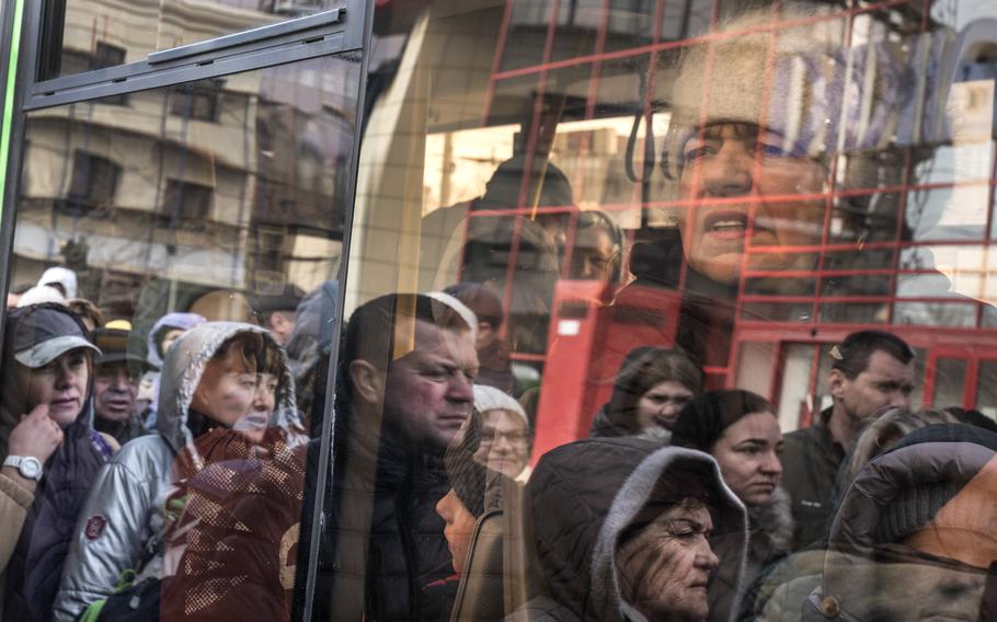 People in Mykolaiv board buses April 5, 2022, to evacuate to Odesa. 