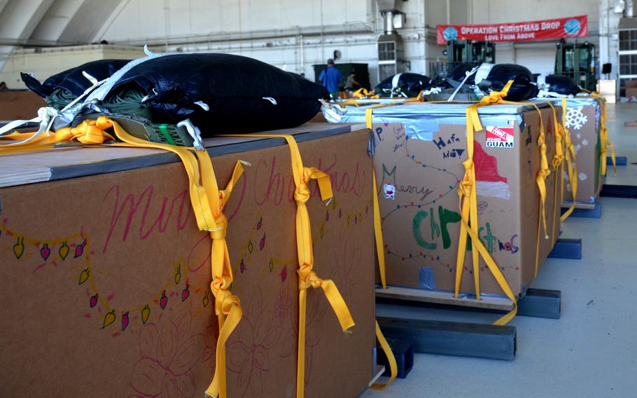 Operation Christmas Drop bundles await the annual humanitarian airlift mission inside a hangar at Andersen Air Base, Guam, Monday, Dec. 5, 2022. 