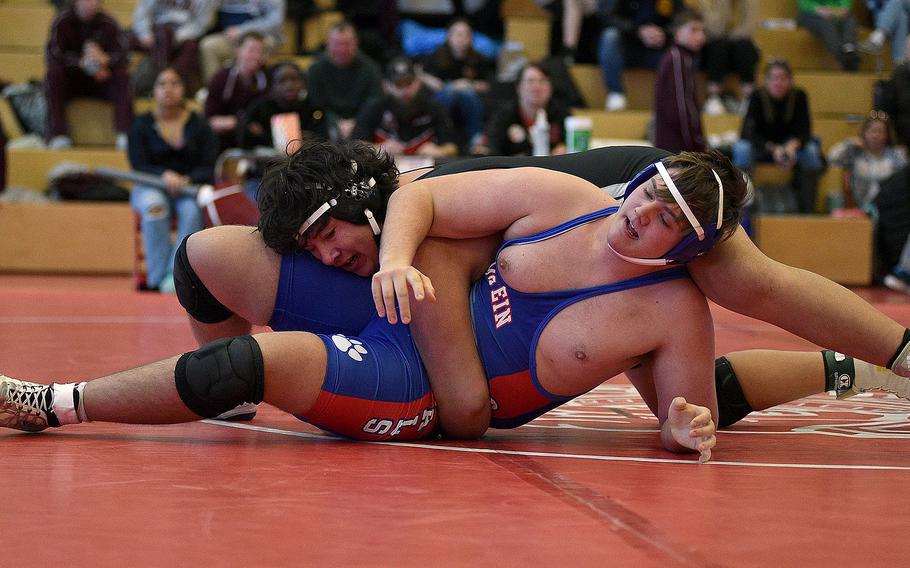 Hohenfels' Brian David holds down Ramstein's Alex Belote during a 285-pound semifinal match at a wrestling meet on Jan. 27, 2024, at Kaiserslautern High School in Kaiserslautern, Germany.