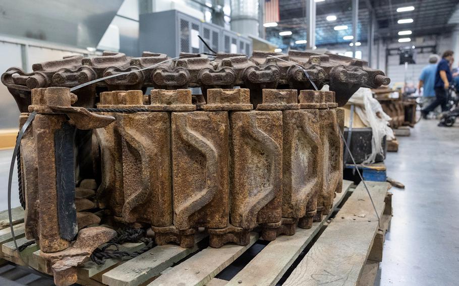 Rusty treads from the M4A3 Sherman tank rest on a pallet.