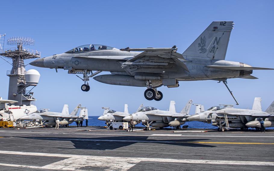 An F/A-18F Super Hornet lands on the flight deck of the aircraft carrier USS Nimitz in the Phillippine Sea, May 12, 2023. In a report released May 16, the Navy pointed to bilge water as the source of jet fuel contamination aboard the ship last fall.