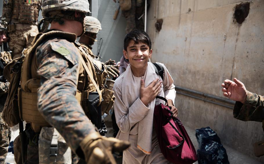 A boy is processed through a checkpoint during an evacuation at Hamid Karzai International Airport, Kabul, Afghanistan, Aug. 18, 2021.