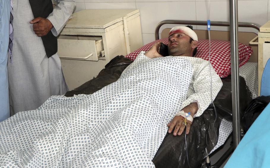 An Afghan man lies at a hospital after a roadside bomb struck a minivan full of university lecturers and students in Kapisa province northern of Kabul, Afghanistan, Saturday, May 29, 2021. 