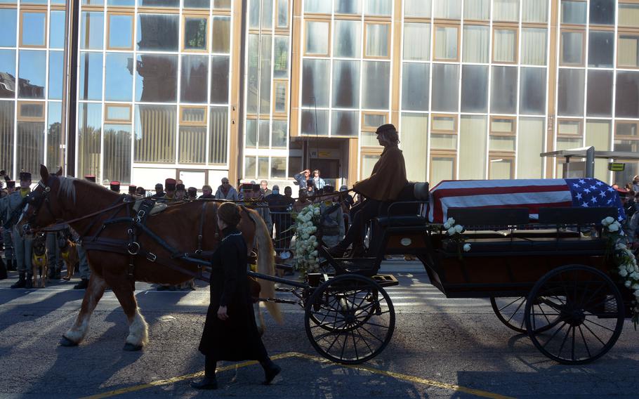 A horse-drawn carriage moves a casket draped in an American flag through the city of Chalons-en-Champagne, France,  on Oct. 24, 2021. The ceremony recreated the journey of the U.S. Unknown Soldier from the city exactly 100 years ago. 