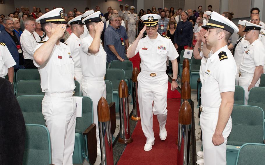 Cmdr. Robert Gillis, the final commanding officer of the Los Angeles-class fast attack submarine USS Chicago (SSN 721), passes through sideboys during a decommissioning ceremony for the submarine.