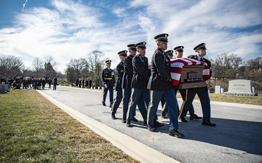 Members of a U.S. Army Honor Guard carry the casket of former Sen. Bob Dole at Arlington National Cemetery, Arlington, Va., on Feb. 2, 2022., as they conduct military funeral honors.