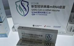 China's first SARS-CoV-2 mRNA vaccine AWcorna, developed by Abogen Biosciences, Walvax Biotechnology, and the Academy of Military Medical Sciences' Institute of Biotechnology, is displayed at the National 13th Five-Year Scientific and Technological Innovation Achievement Exhibition in Beijing, China on Oct. 27, 2021. More than two years into the pandemic, China has not approved the more effective mRNA vaccines, instead choosing to pursue its own route on COVID-19 vaccines. 