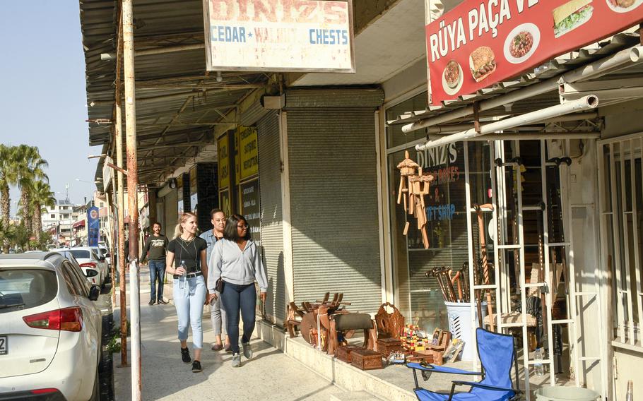 Master Sgt. Jessyca Boyd, front right, examines wares for sale along an area known as American Alley outside the gate of Incirlik Air Base in southern Turkey on Feb. 27, 2023. 