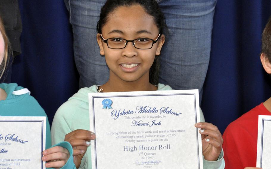 Naomi Jack shows off her high honor roll certificate from Yokota Middle School at Yokota Air Base, Japan, in 2015.