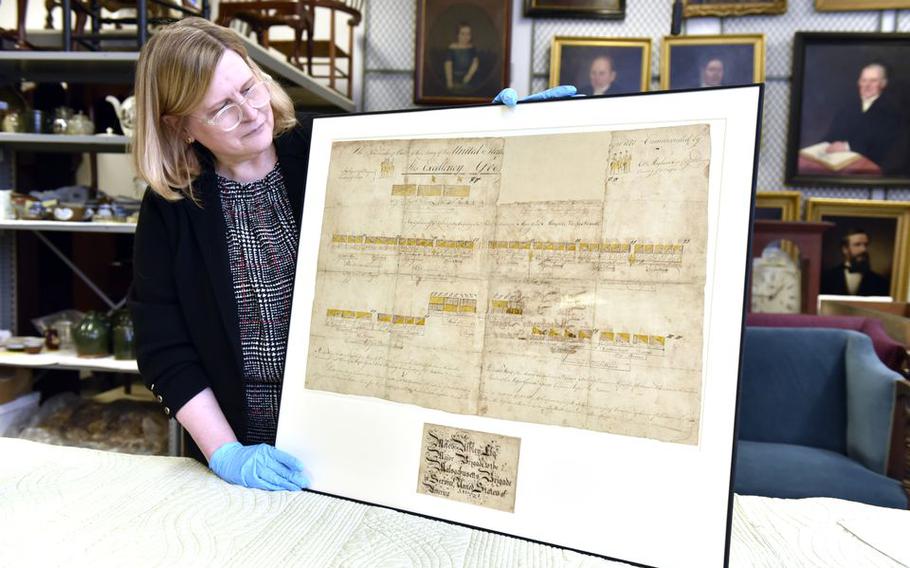 Amanda Lange, Curatorial Department Director and Curator of Historic Interiors at Historic Deerfield, looks over the recently restored Revolutionary War battle plan document by Major Moses Ashley of Westfield.