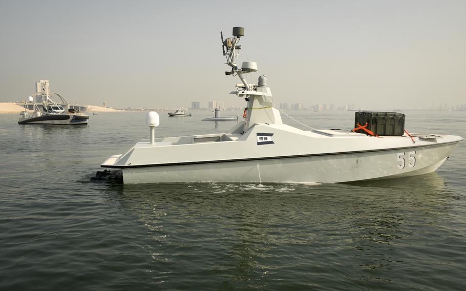 Unmanned ships with green boxes containing aerial drones prowled the waters near Naval Support Activity Bahrain, Dec. 1, 2022, as part of an exercise that was the first test for 10 systems by the U.S. 5th Fleet. 