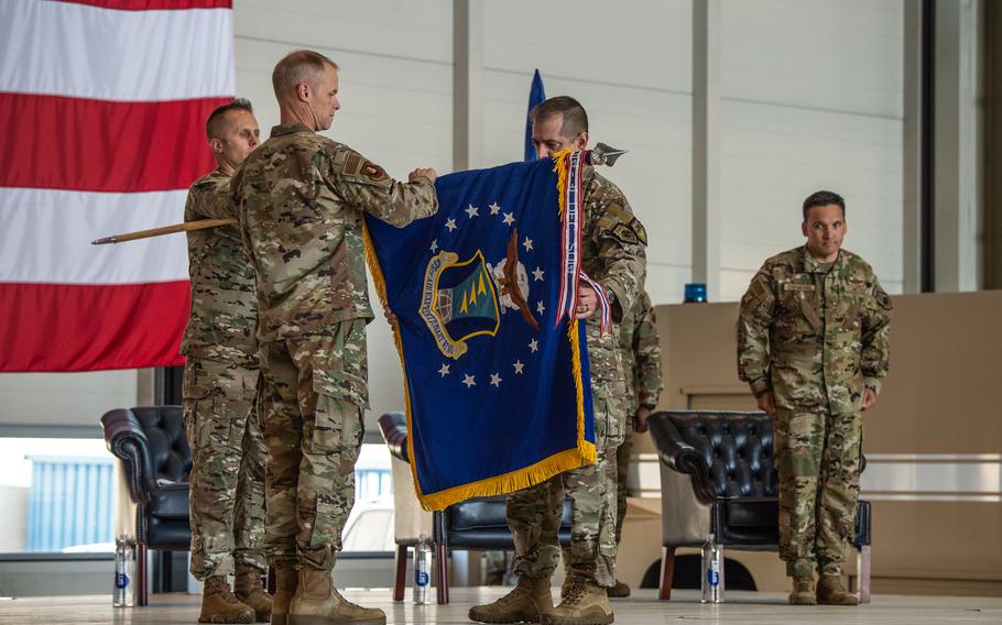 Maj. Gen. Derek France, the 3rd Air Force commander, left, and Col. Bryan Callahan perform the ceremonial casing of the colors for the 435th Air Expeditionary Wing's inactivation at Ramstein Air Base, Germany, on June 9, 2023. The wing was activated in 2013 and provided tactical airlift, personnel recovery, casualty evacuation, base operations support and direct logistics management.