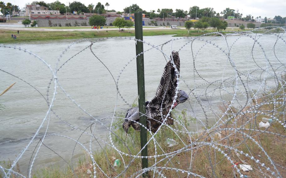 Coiled barbed wire placed by the Texas National Guard along the Rio Grande in Eagle Pass, Texas, as seen on May 23, 2022. Texas has sued to stop federal border agents from cutting the wire to allow migrants to pass through.