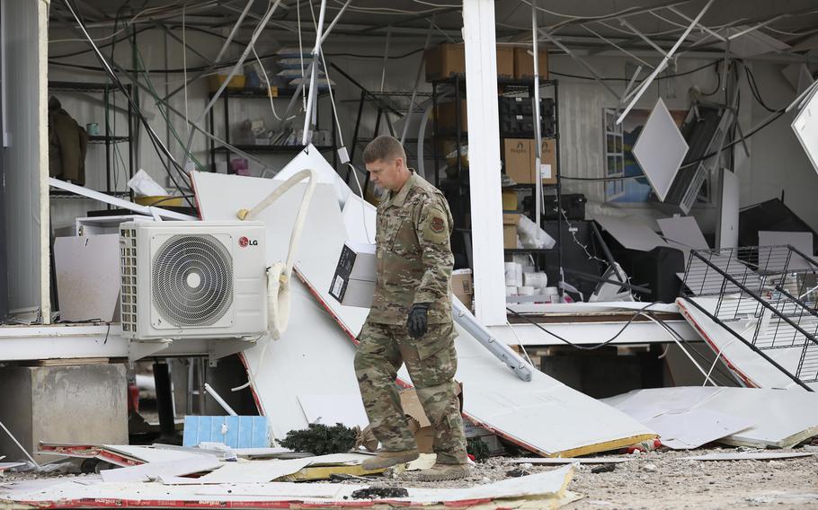 A U.S. airman searches for salvageable items in the debris caused by Iranian missile attacks at al Asad Air Base, Iraq in January 2020. Iran's influence in Iraq has become entrenched in the 20 years since the U.S. removed Saddam Hussein from power.