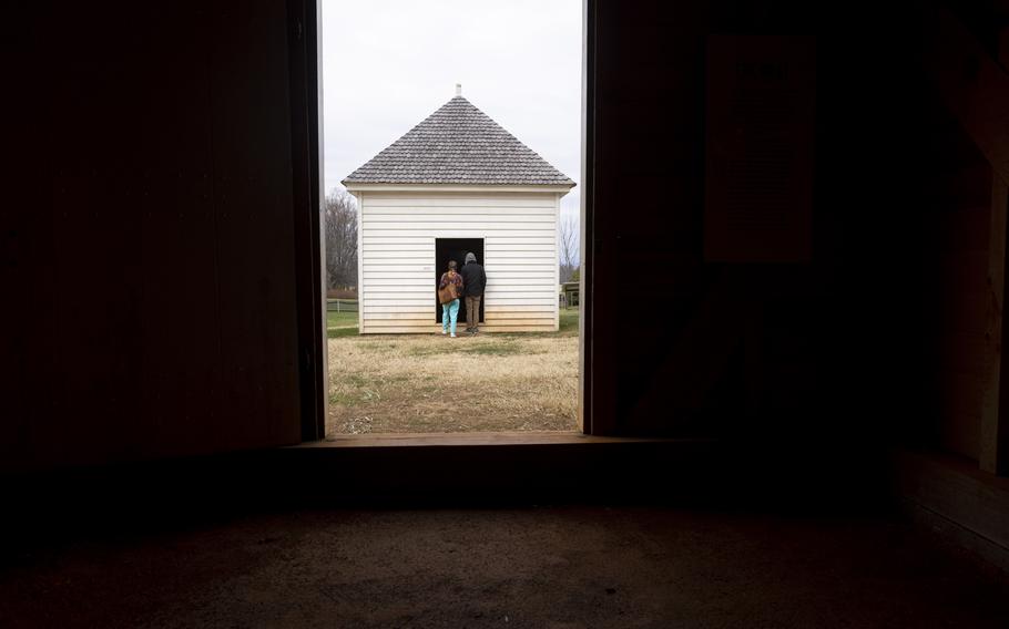 Visitors tour the replica slave quarters at Montpelier, home of America’s fourth president, James Madison. 
