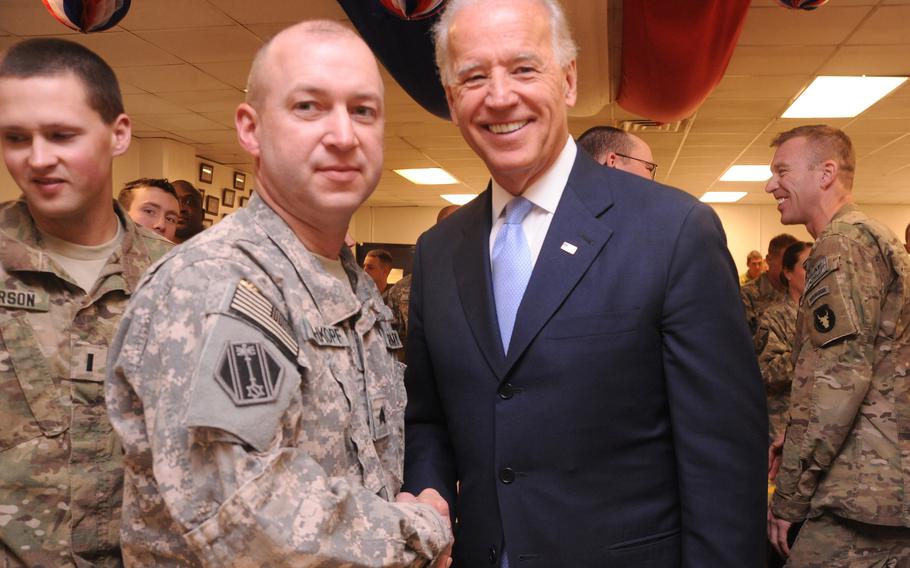 Sgt. Arther Rehkopt, 46th Military Police Command, shakes hands with Vice President Joe Biden at Bagram Airfield, Afghanistan in December 2011. As president, Biden ordered the complete withdrawal of U.S. troops from Afghanistan by Sept. 11, 2021.