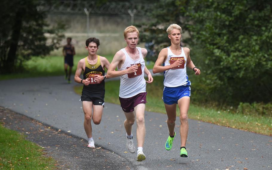 Vilseck runner Jackson Cochran, center, leads the boys 5-kilometer race, followed closely behind race winner Luke Jones, right, from Wiesbaden and Carter Lindsey from Stuttgart during the first lap of the 3.1-mile cross country race at Vilseck, Germany, Saturday Sept. 10, 2022. Jones and Cochran went on to finish 1-2 in the season-ending championships.