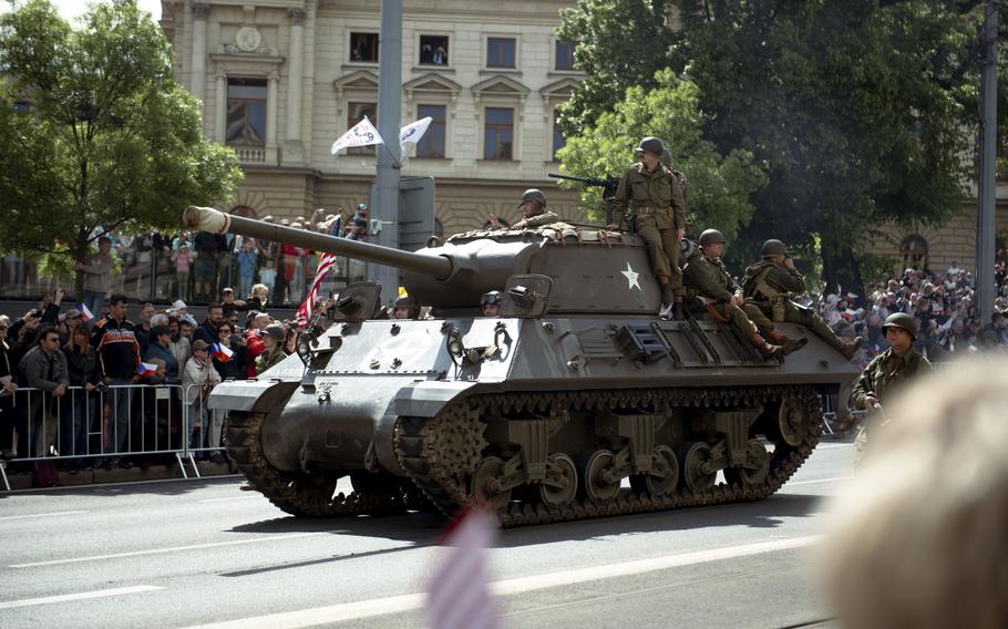 A tank rolls down the street.