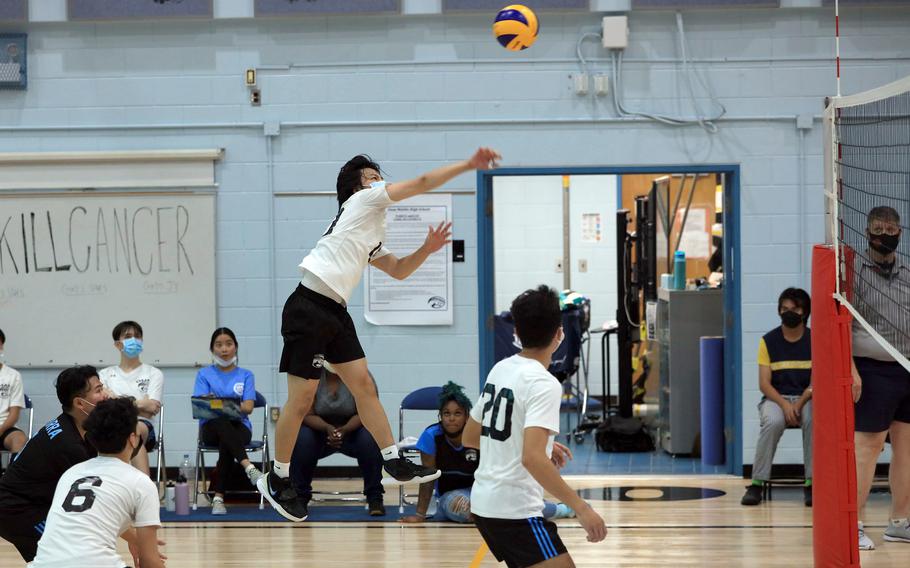 Dash DeSilva of Osan sends a spike over the net against Taejon Christian during Saturday's Korea boys volleyball match. The Cougars won in three sets.